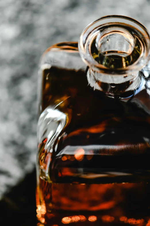 a small brown glass jar containing liquid or vinegar