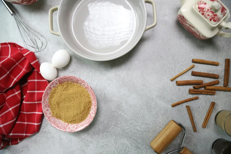 various ingredients on a table including coffee, sugar and cinnamon sticks