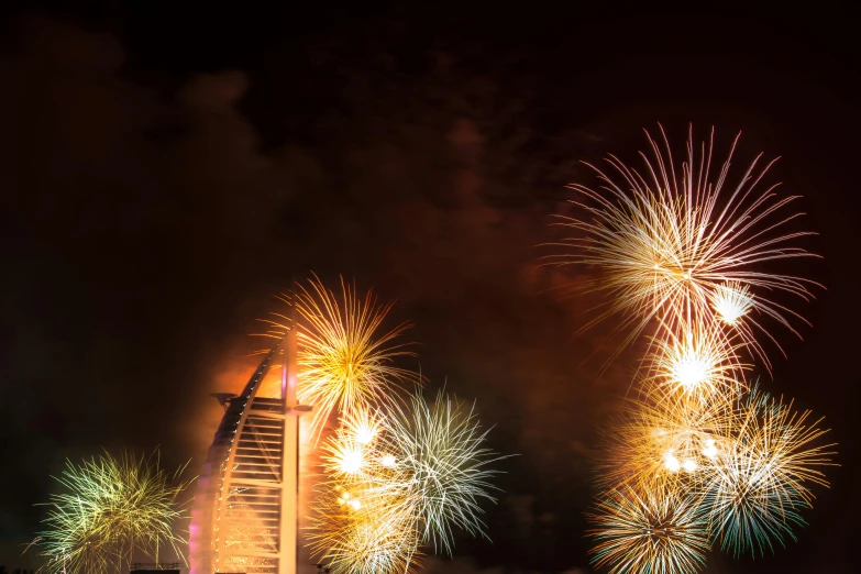 a fireworks is in the sky above a tall building