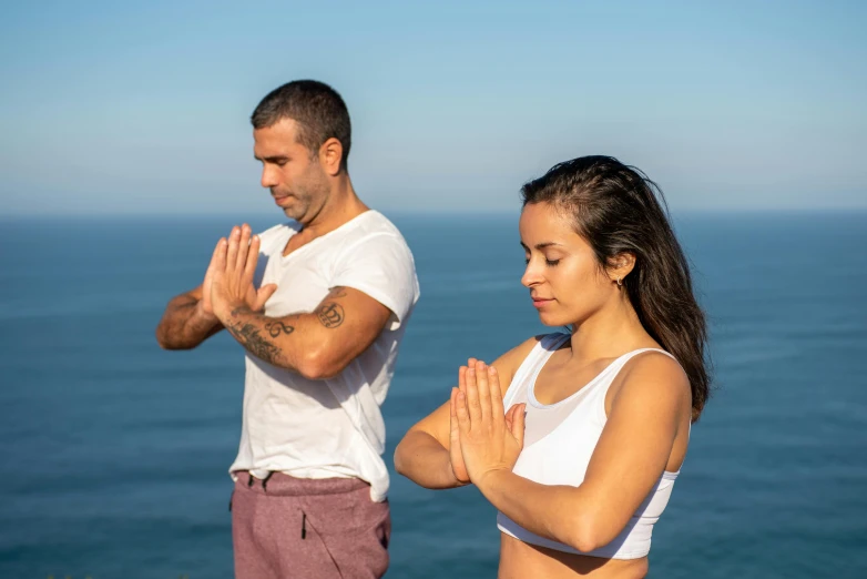 a young woman clapping her hands while another man watches