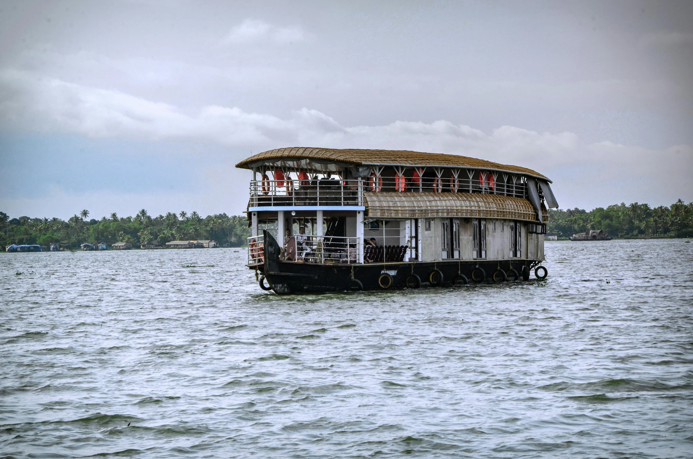 this boat is floating in the water with people on it