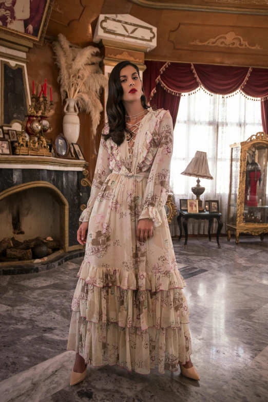 a woman in an elegant dress standing inside a house