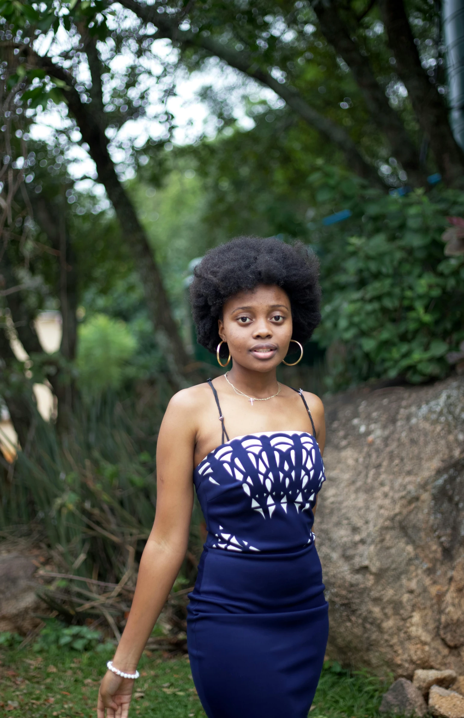 a woman with an afro walking down the grass