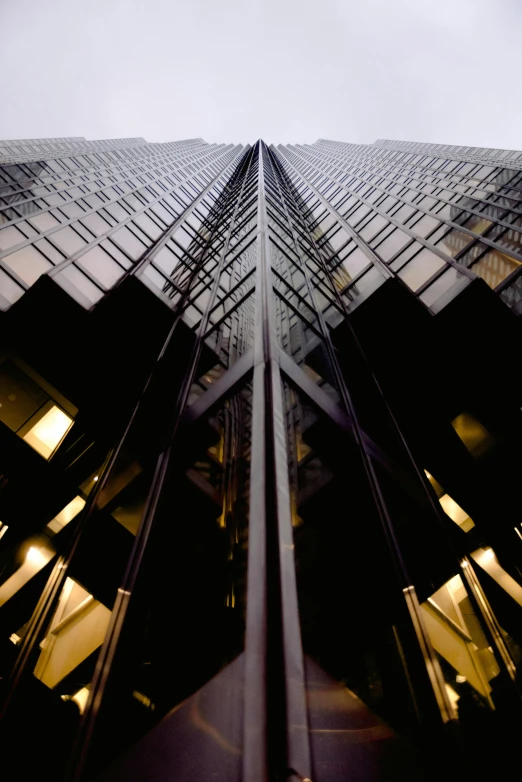 a tall building sitting in front of an office block