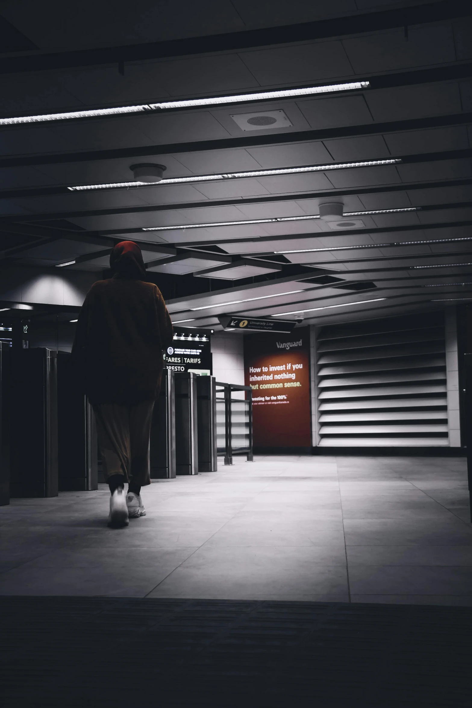 a person walking down a large walkway into a tunnel