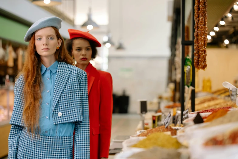 two women at a market standing close together