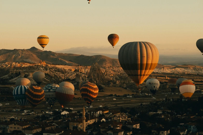 many  air balloons flying over some desert