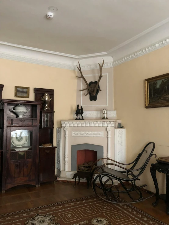 a vintage rocking chair sits in the middle of an old living room