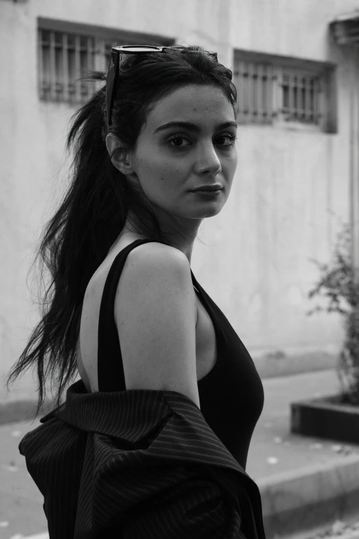 a girl walking down the street with her hair in the wind