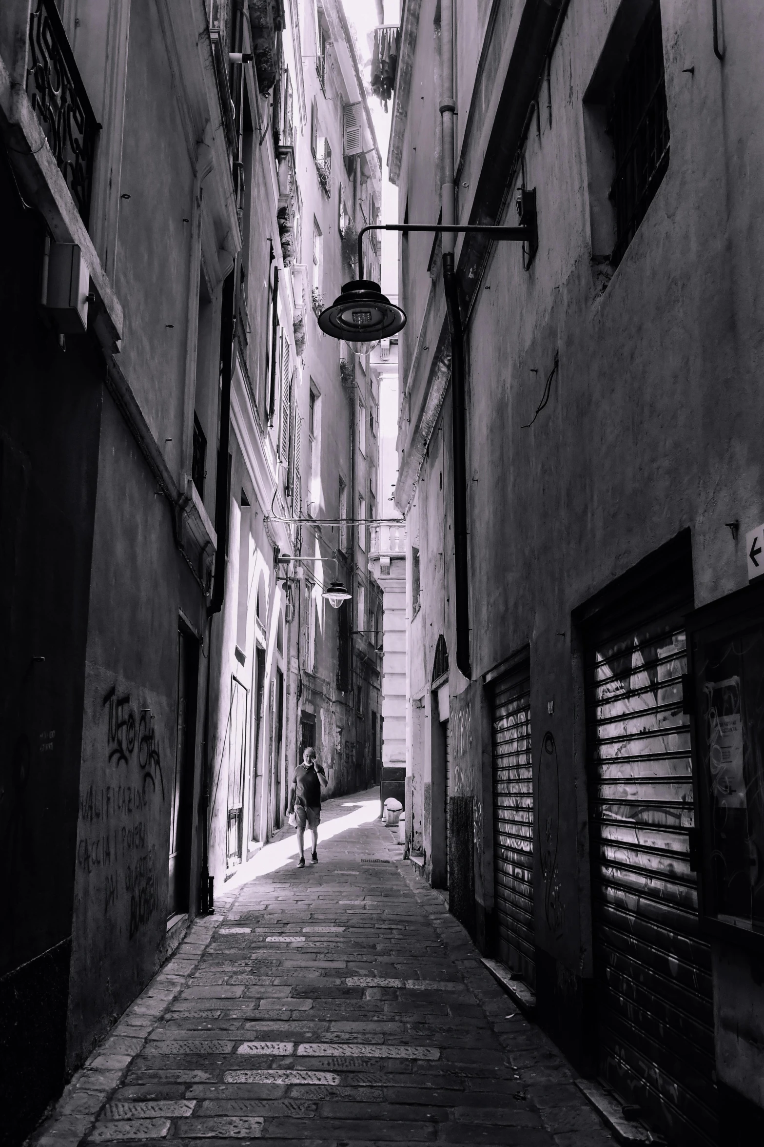 black and white image of a street with buildings in the background