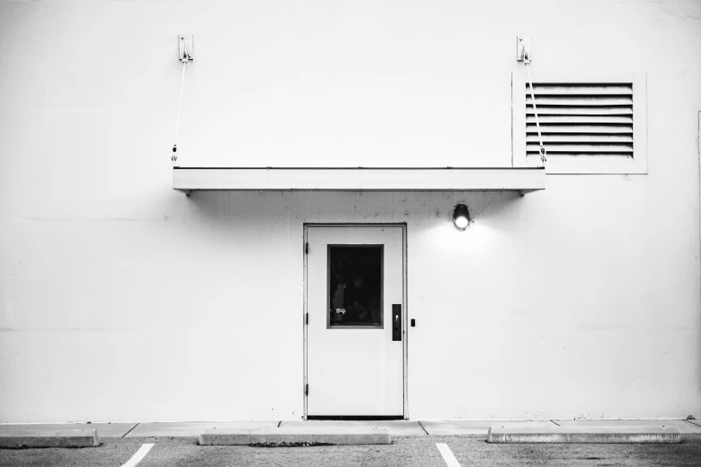 the door to the building is in front of the closed windows