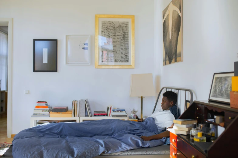 a person is sitting in bed and reading a book