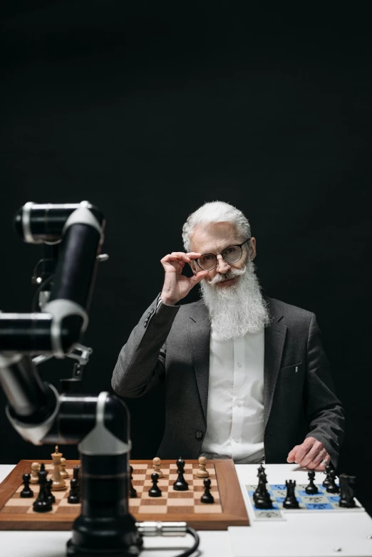 a man with white beard and bearding playing chess