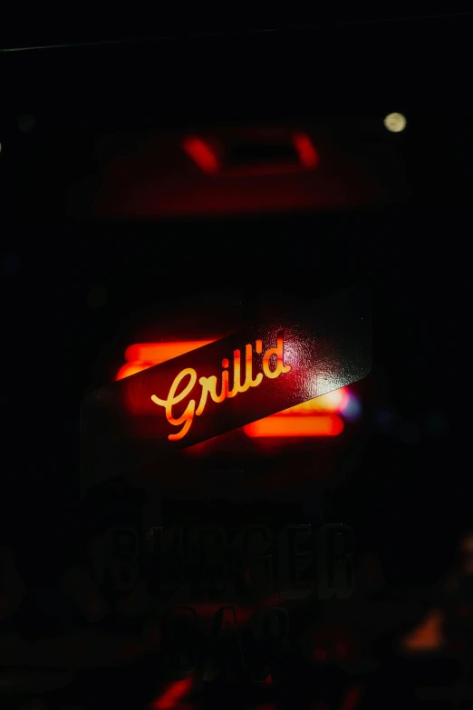 a neon sign in a dark room lit up