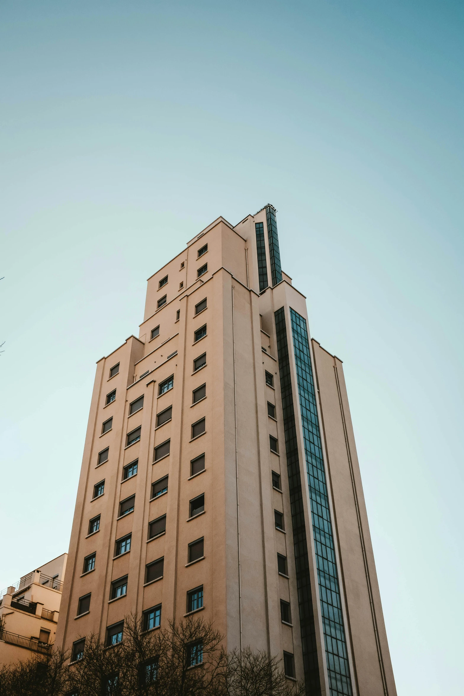 a large white building with windows under a blue sky