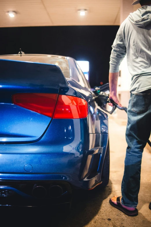 the man is charging the electric vehicle