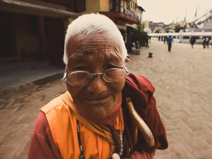 a man with a wooden stick wearing glasses