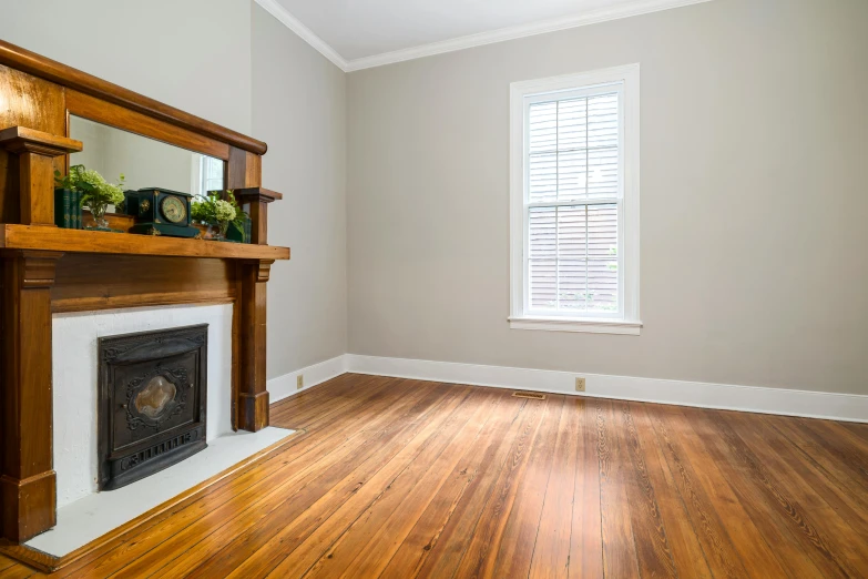 a living room with wood floors and a window