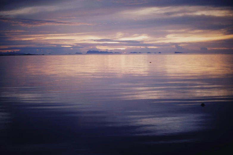 a distant horizon across the ocean at night