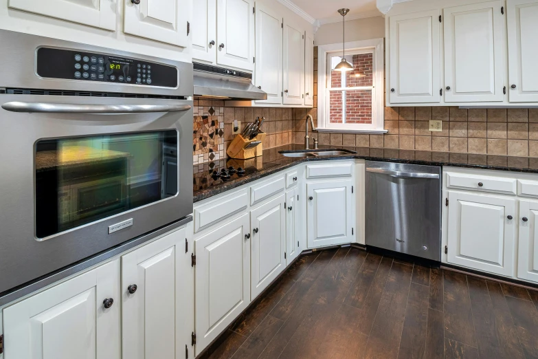 a kitchen with a silver stove top oven sitting inside of it