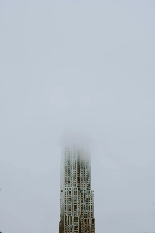 a very tall building with some buildings in the background