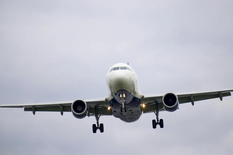 an airplane is flying in a cloudy sky