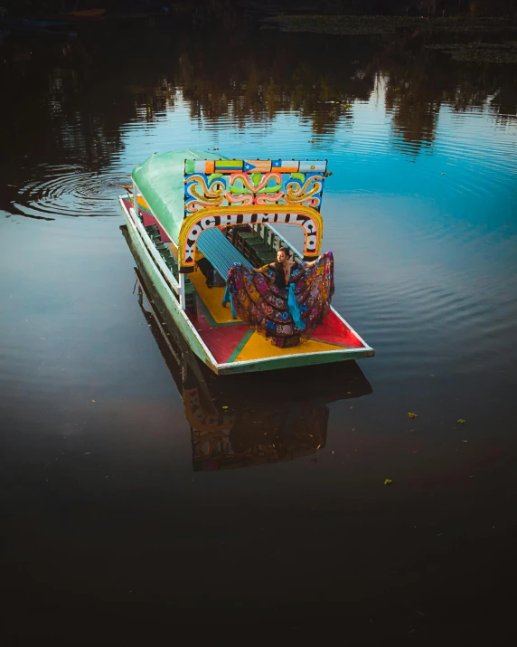 a brightly colored boat sits in the water