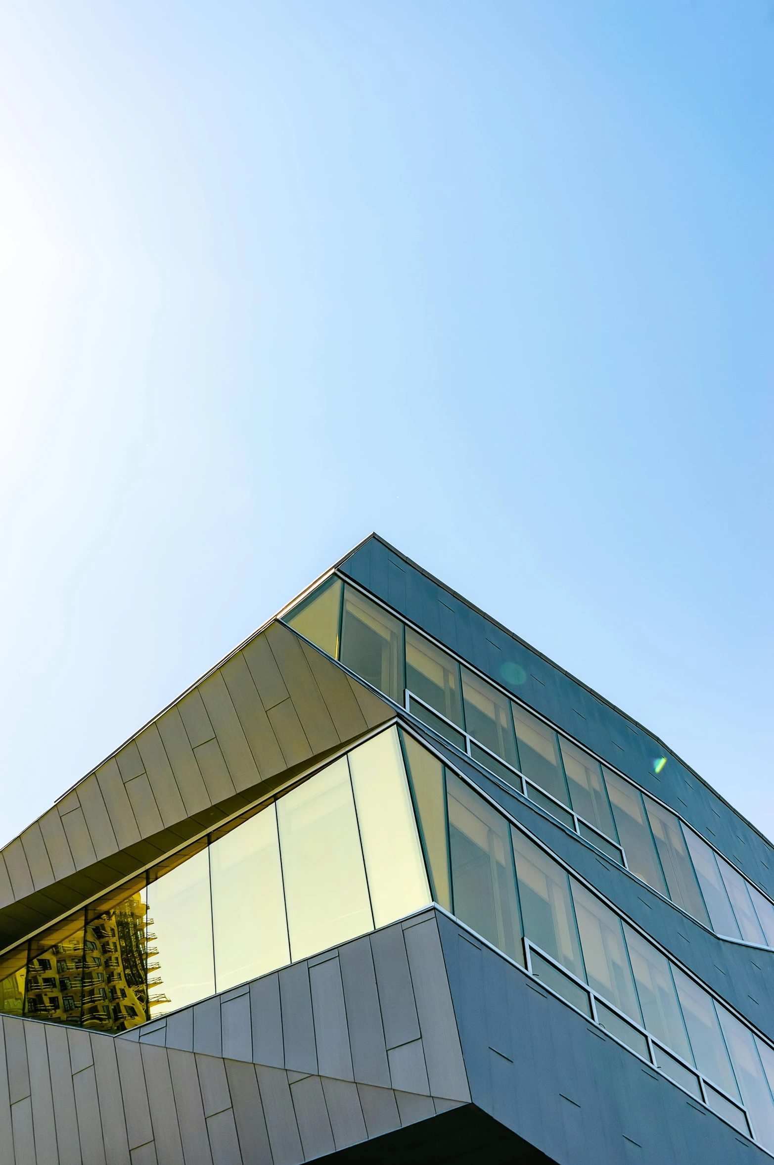 an upward view from underneath a building with several windows