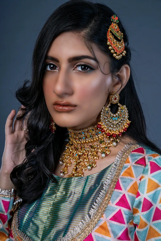 a woman with jewellery in front of a dark background