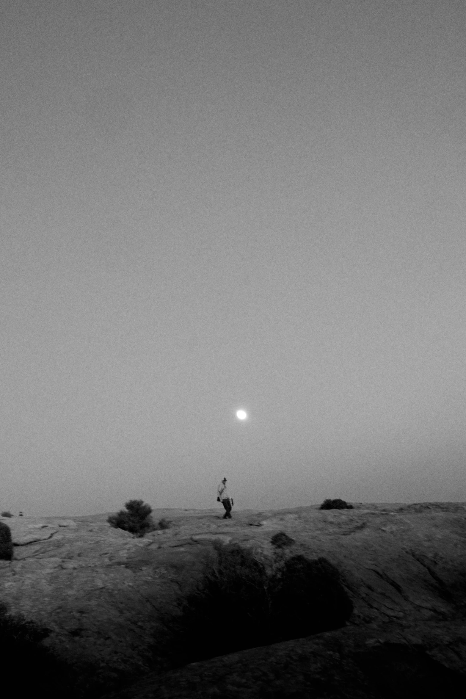 a person standing on a hill in the dark