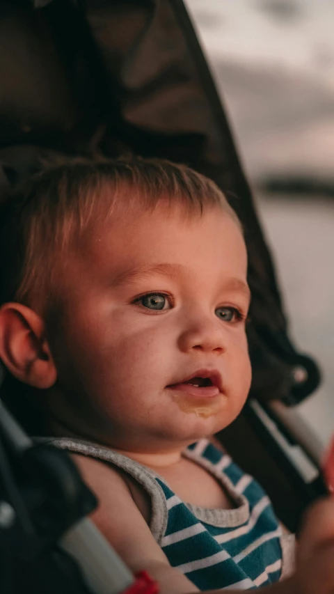 a baby is sitting inside of a stroller