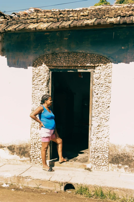 a woman that is standing near a building