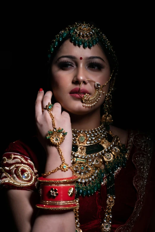 a woman is wearing some jewels and jewelry