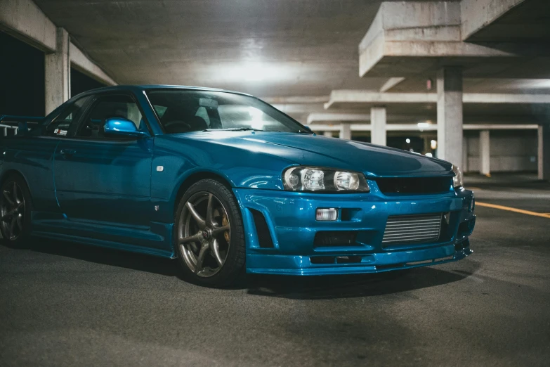 a blue subarunt in parking lot with building