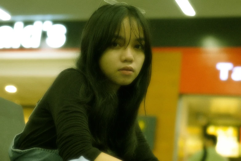 a girl is sitting down in the middle of an airport