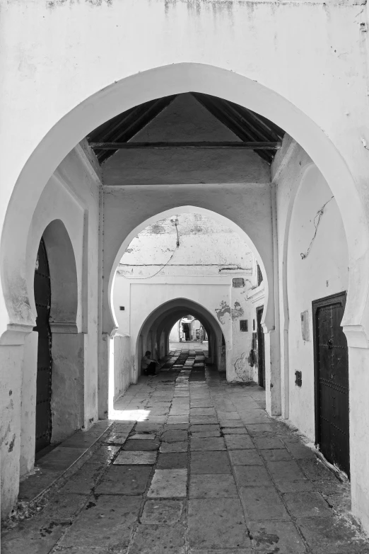 an arched street with archways and doors on both sides