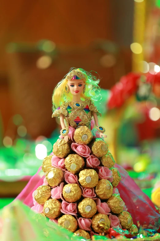 a barbie doll dressed in dress and surrounded by candy