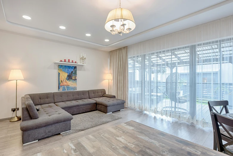 a living room with couches and a chandelier above it