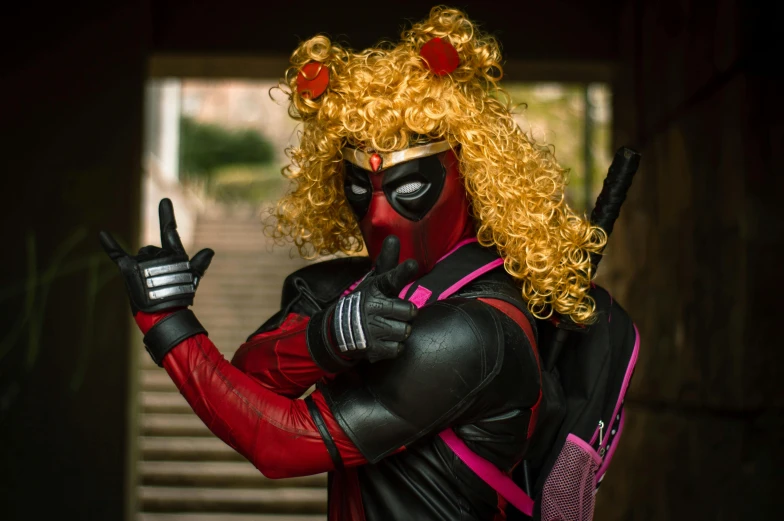 a man in black and red wig wearing a deadpool makeup