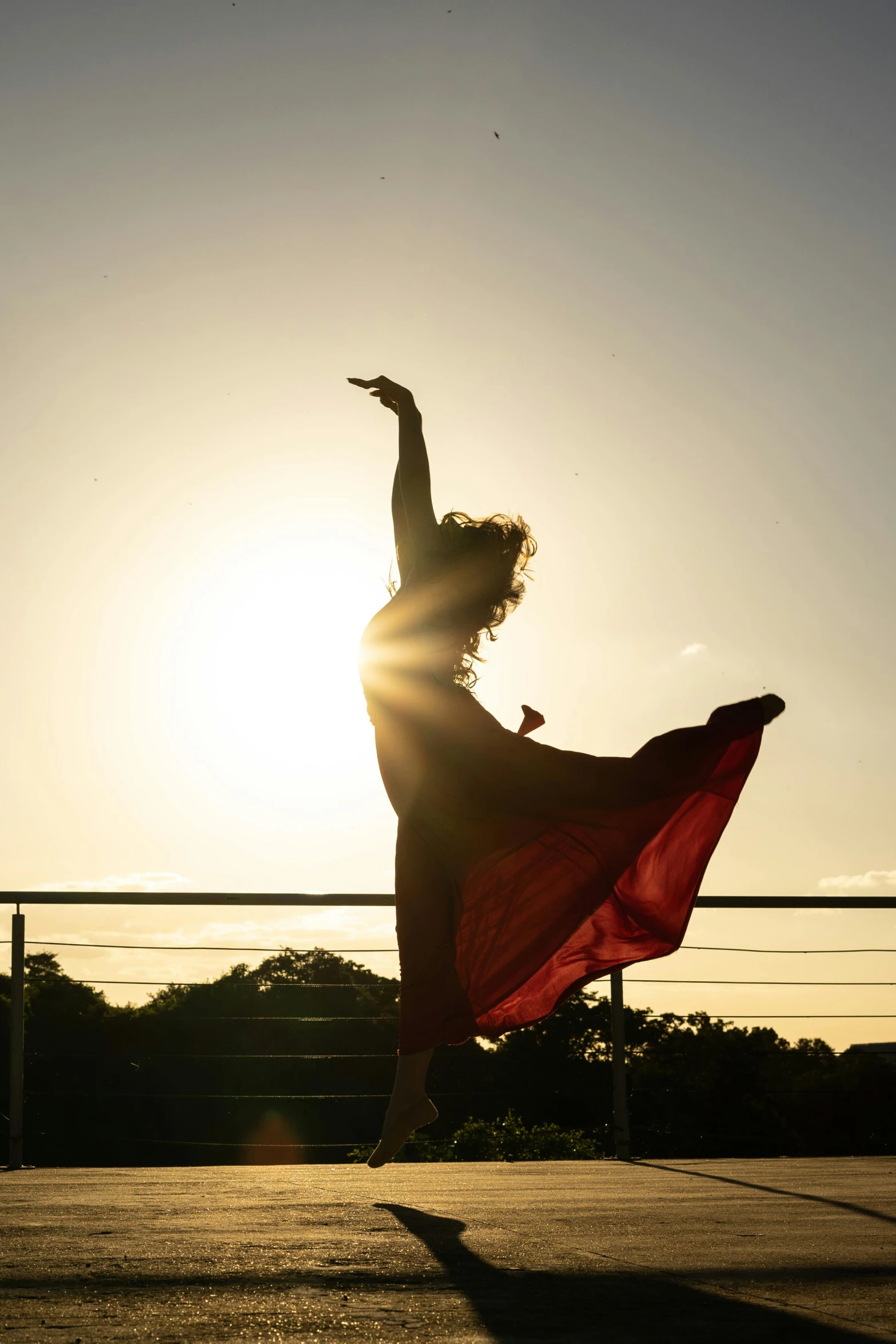 a woman in a dress jumping into the air