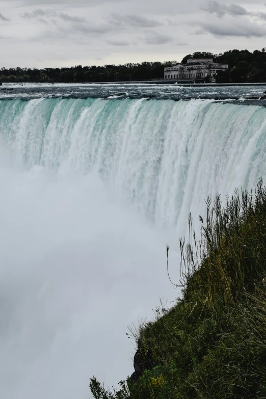 an island next to a waterfall has a clock displayed