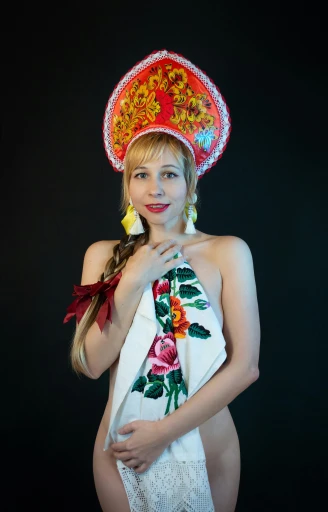a woman wearing an elaborately designed headpiece poses for a po