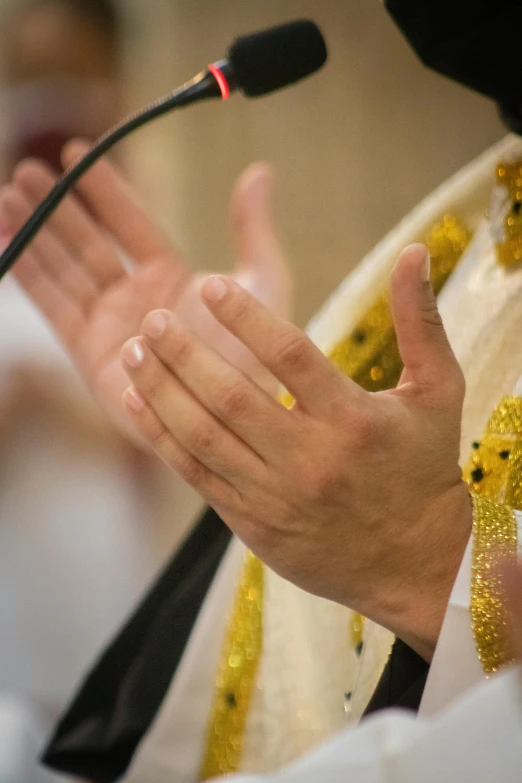 hands are praying at the alter during a wedding ceremony