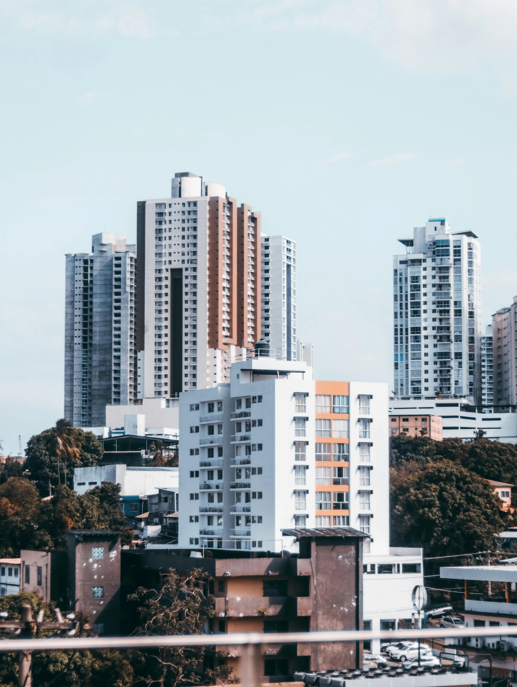 tall apartment buildings on the horizon behind a city