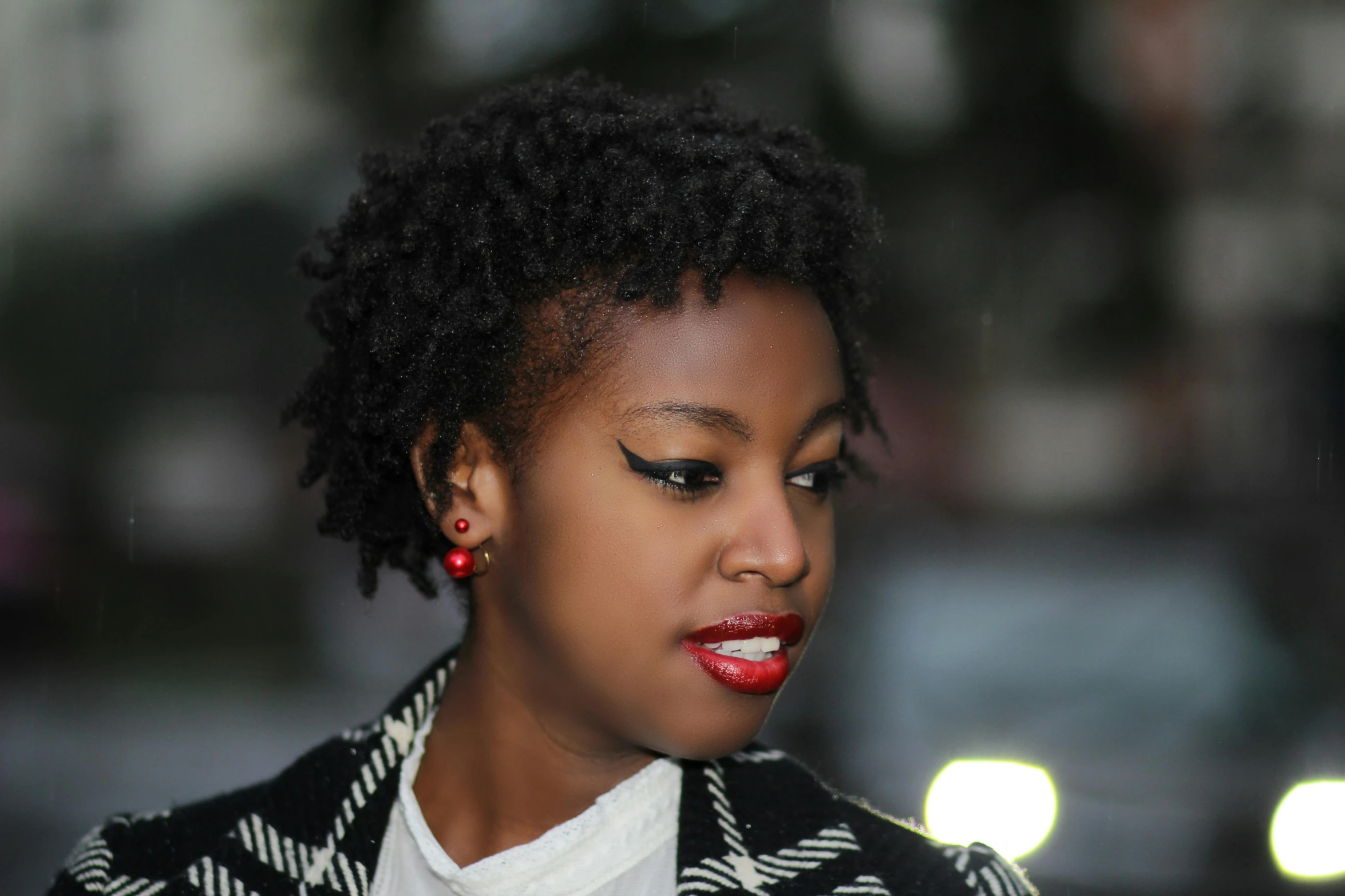 the woman is posing for a po while wearing her lipstick