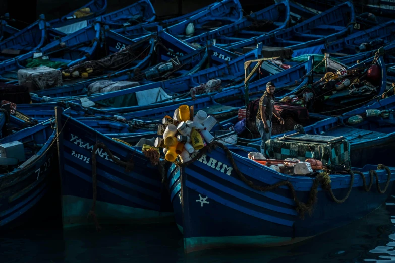 a large group of blue boats on the water