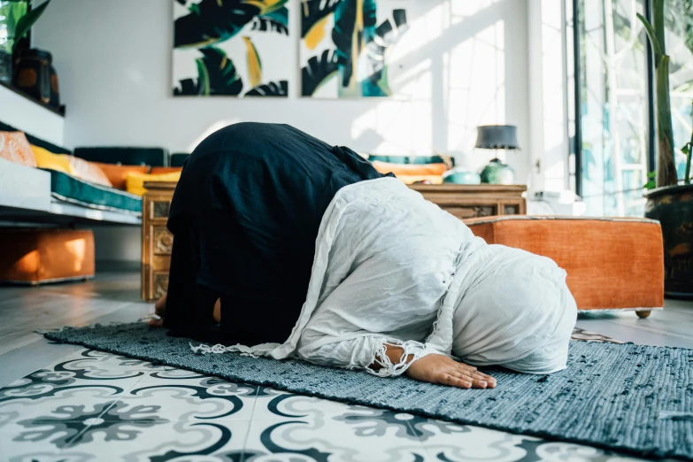 a woman dressed in a veil laying on the floor