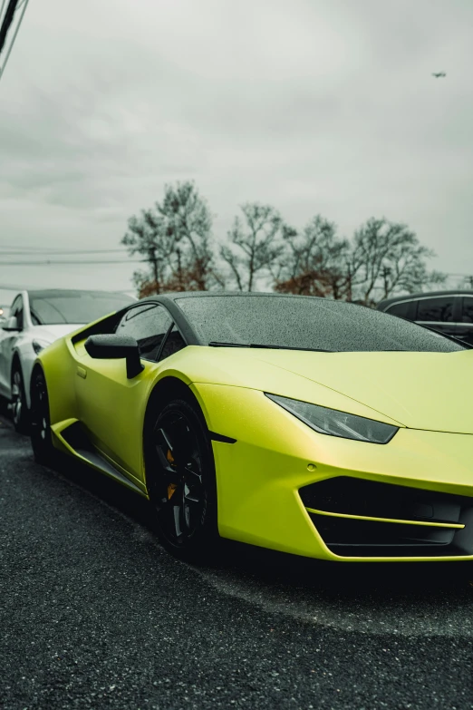 a yellow lambs is parked next to a white car