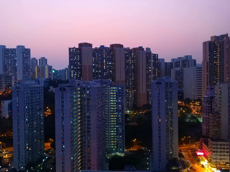 tall buildings line the skyline in a city at twilight