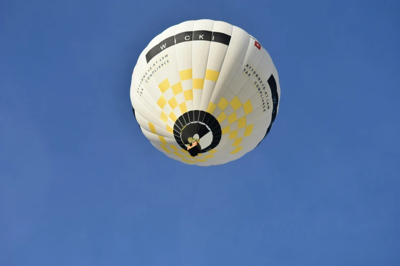 a  air balloon flying through a blue sky